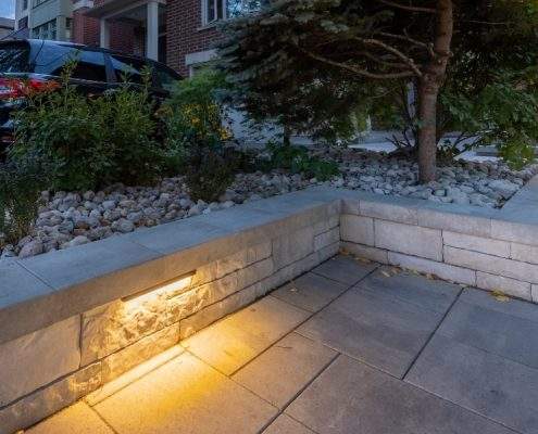 custom retaining ahs wall with glass railings lighting