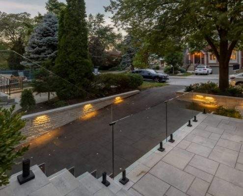 custom retaining wall toronto with glass railings lighting