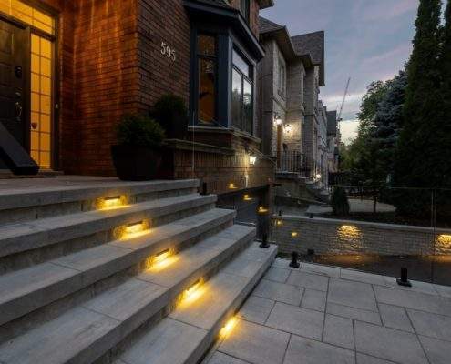 custom retaining wall with glass lighting railings