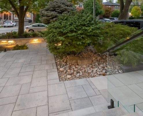 custom retaining wall with glass railings lighting