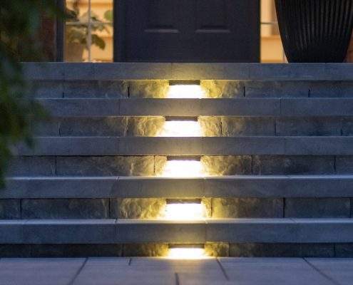 custom retaining wall with glass railings lighting ahs toronto