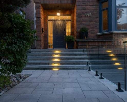 custom retaining wall with railings lighting glass