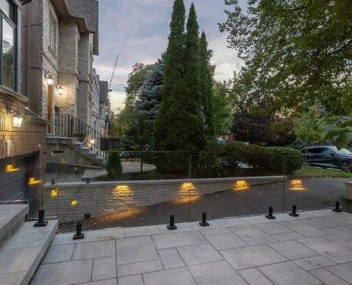custom toronto retaining wall with glass railings lighting