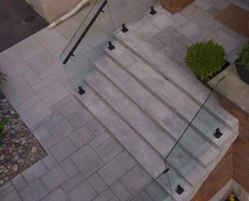 glass custom retaining wall with railings lighting
